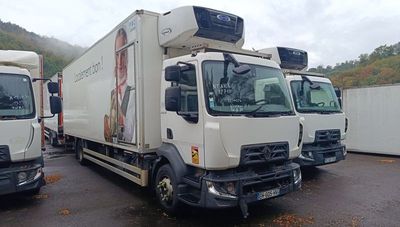 three trucks that are parked in a parking lot
