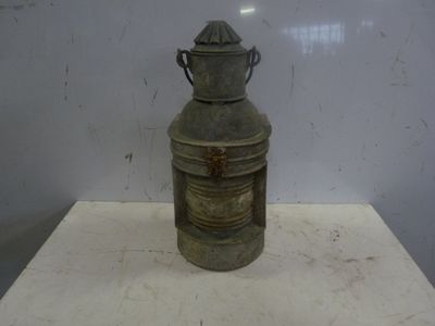 a small metal container on a table with a handle