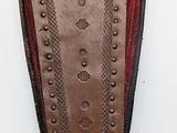 leather shoe with rivets and studs on a white surface
