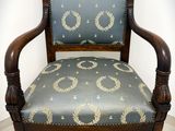 an old chair with a blue upholstered upholstered seat