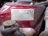 a close up of a red motorcycle engine with a tag on it