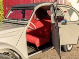 a small car with a red seat in front of a building