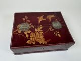 a small wooden box with birds and flowers on it