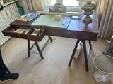 a woman taking a picture of a desk in a living room