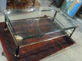 une table basse en verre posée sur un tapis au sol