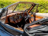 a black car with a wooden dashboard and steering wheel
