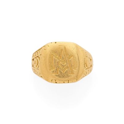 un gros plan d'une bague en or ornée d'un symbole maçonnique