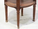 a wooden table with a glass top on a white surface