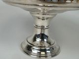 a silver plate with a cake on top of it