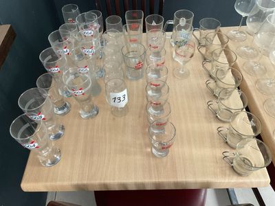 a lot of empty glasses on a table with a price tag