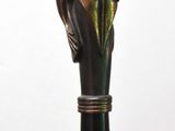a statue of a hand holding a cane with a bird on it