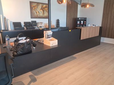 a desk with a bag on it in a room with wood floors