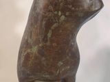 statue of a cat sitting on a pedestal on a white background