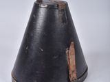 a black bell with a brown leather strap on it