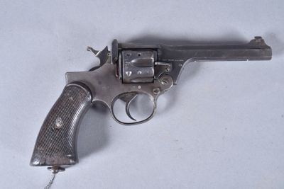 a gun that is sitting on a white surface