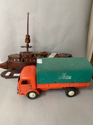 a toy truck that is sitting next to a ship