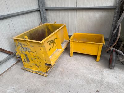 two yellow bins are sitting next to each other in a garage