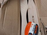 several wooden spoons in a cardboard box on a table
