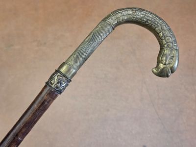 a close up of a cane with a handle on a table