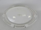 a white plate with a gold rim sitting on a table