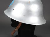 a silver helmet with a blue star on the side