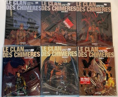 six books of comics on a table with a white background