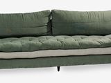 an image of a green couch with pillows on it