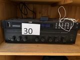 a close up of a radio sitting on top of a wooden shelf