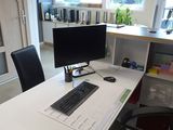 a desk with a keyboard and a monitor on it