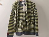 yellow and grey striped cardigan sweater hanging on a hanger