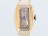 a close up of a gold watch with a white face