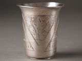 a silver cup that has a design on it