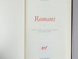 someone is holding a book open to a page with romans written on it