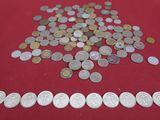 a pile of coins on a table with a red cloth