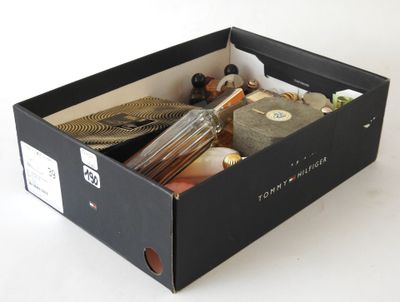 a black box filled with assorted items on a white surface