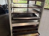 a metal cart with a bunch of trays on it