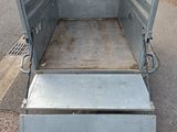 a truck bed that is open on the side of the road