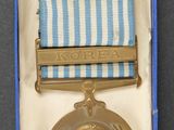 a small medal in a blue box on a table