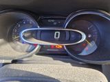a car dashboard with a speedometer and a steering wheel