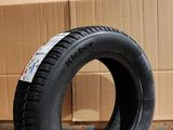 a tire that is sitting on the floor next to a cardboard box