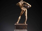 an image of a bronze statue of a woman holding a basketball ball