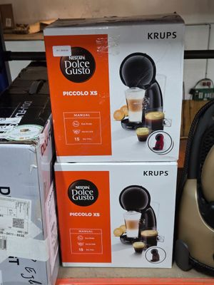 three boxes of coffee machines on the shelf in the store