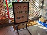 une pancarte placée devant une porte sur laquelle est apposée une étiquette de prix