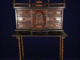 an antique desk with a wooden top and ornate carvings on the top