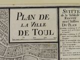 an old map of a town with a map of the streets