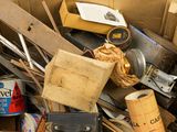 a cardboard box full of assorted items and tools