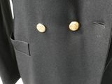 a close up of a suit with gold buttons on it