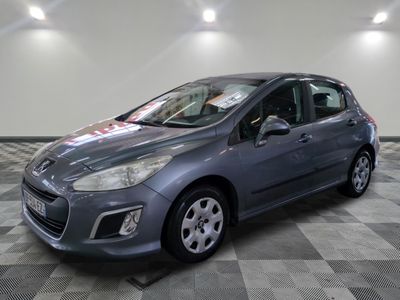 the grey car is parked in the garage on a checkered floor