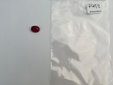 a red pill in a white bag on a table