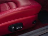 a close up of a red leather seat in a car